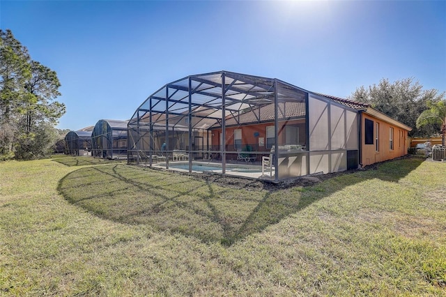 view of yard featuring glass enclosure and cooling unit