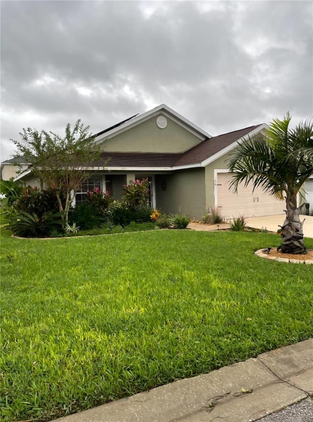 ranch-style house with a garage and a front yard