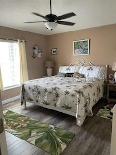 bedroom featuring ceiling fan and dark hardwood / wood-style floors