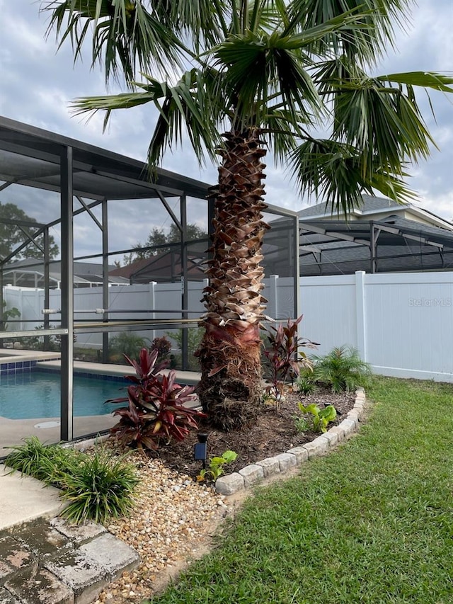 exterior space with a lawn and a lanai