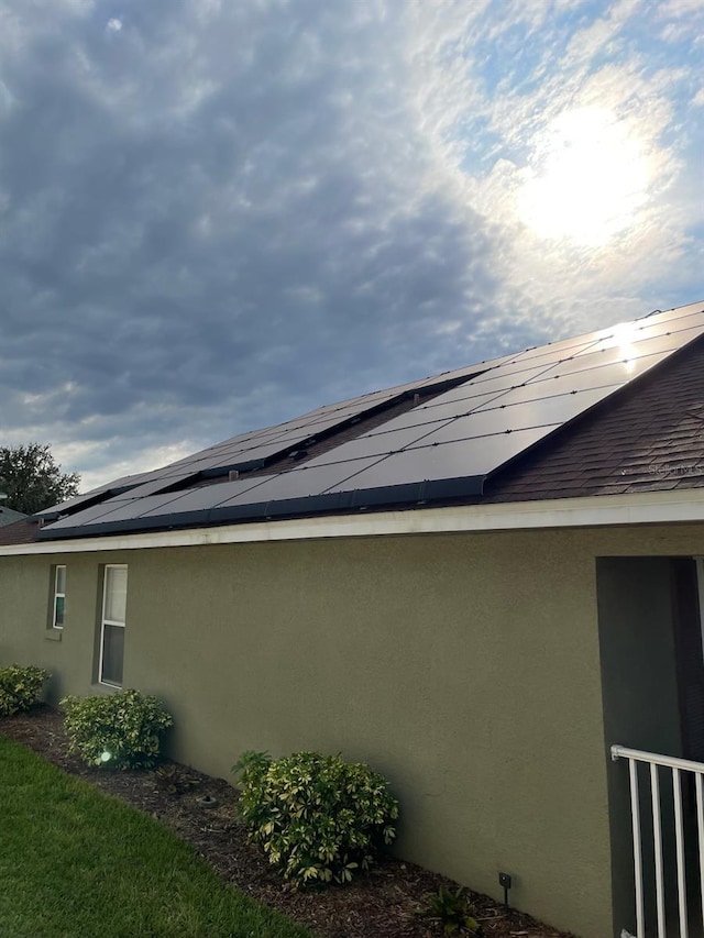 view of home's exterior with solar panels