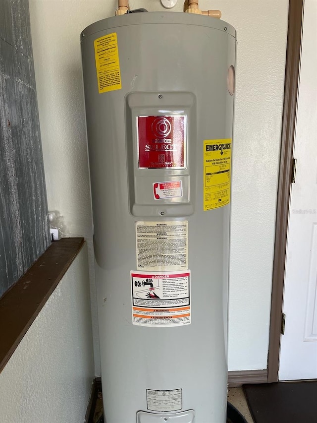 utility room with electric water heater