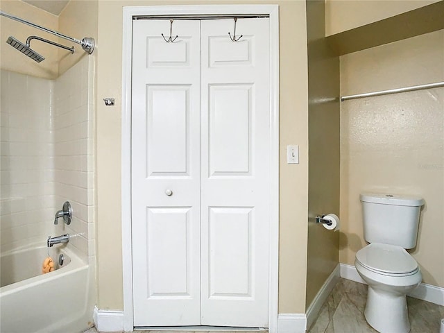 bathroom featuring toilet and shower / bathtub combination