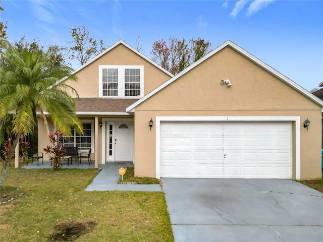 view of front property featuring a front yard and a garage