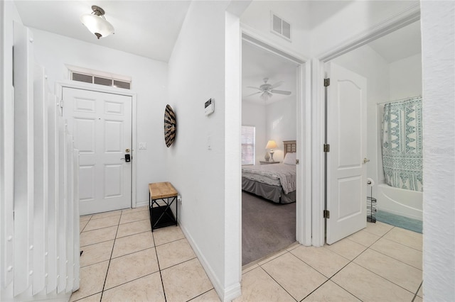 foyer featuring ceiling fan and light tile patterned flooring