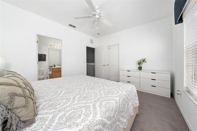 bedroom with carpet flooring, ceiling fan, a closet, and ensuite bath