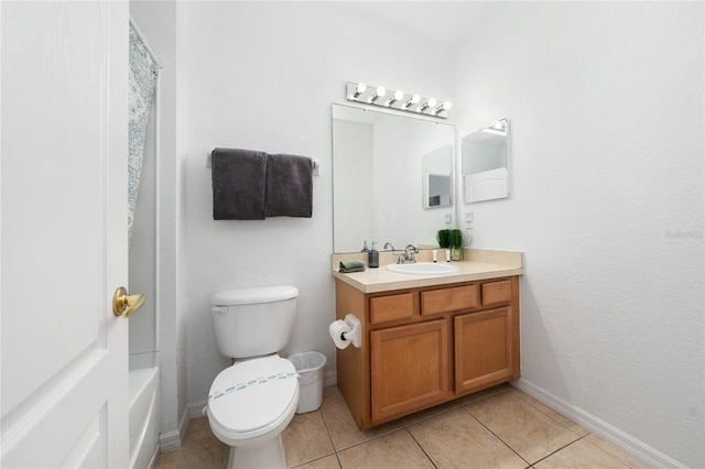 bathroom featuring toilet, vanity, and tile patterned floors