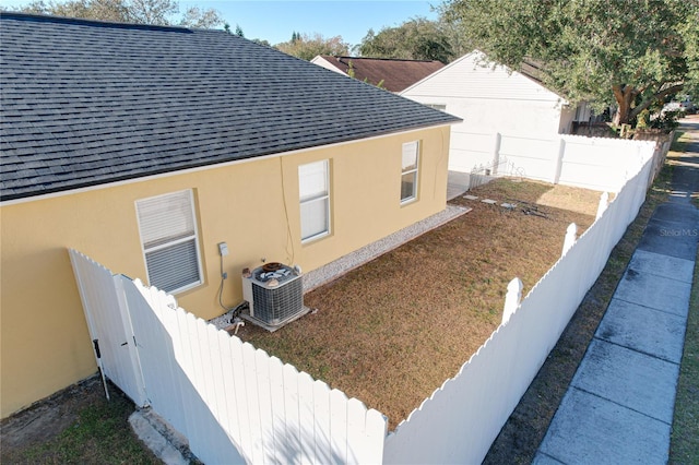 view of side of home with central AC unit