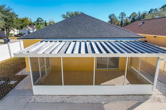 back of property featuring a patio area and a sunroom