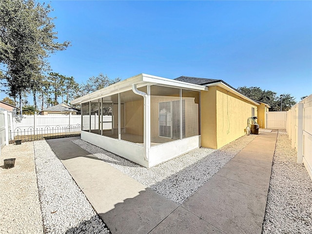 view of side of property with a sunroom