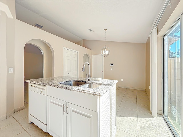 kitchen featuring dishwasher, sink, light tile patterned floors, an island with sink, and white cabinets