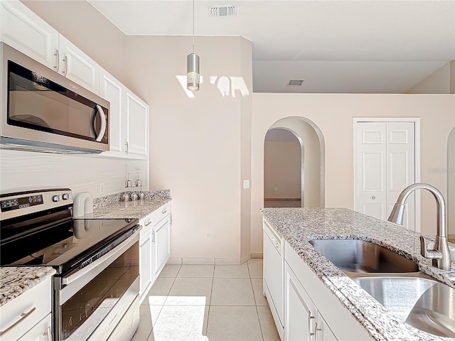 kitchen featuring pendant lighting, white cabinetry, sink, and appliances with stainless steel finishes