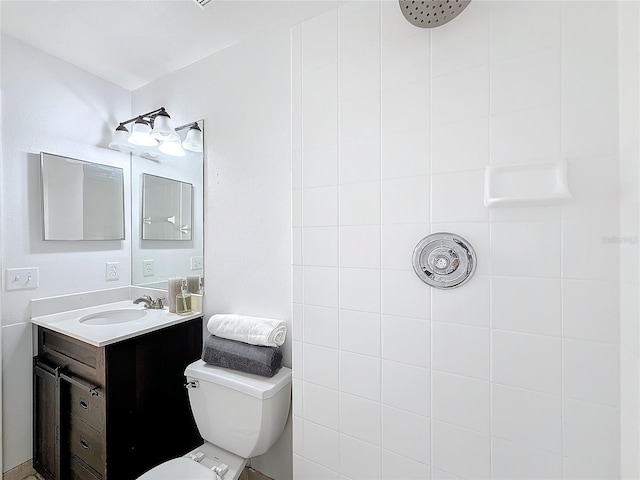 bathroom featuring vanity, toilet, and walk in shower