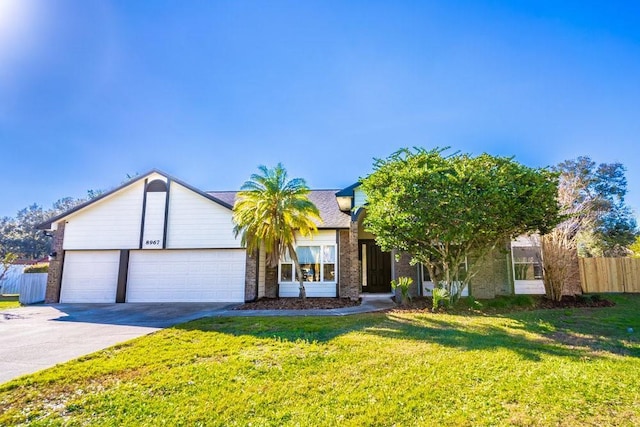 view of front of property with a front lawn and a garage