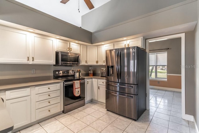 kitchen with white cabinets, light tile patterned floors, and appliances with stainless steel finishes