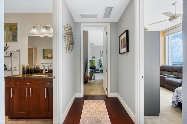 corridor featuring dark hardwood / wood-style flooring and sink