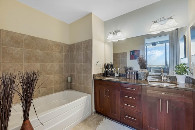 bathroom with a bathtub, vanity, and tile patterned flooring