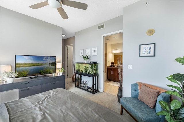 bedroom featuring ensuite bathroom, ceiling fan, and light colored carpet