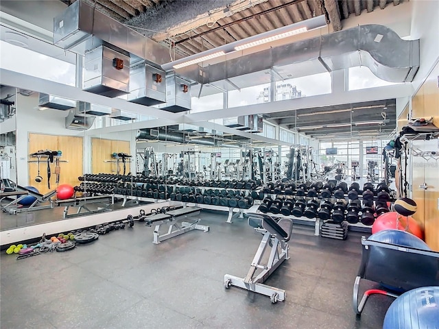 gym with a towering ceiling