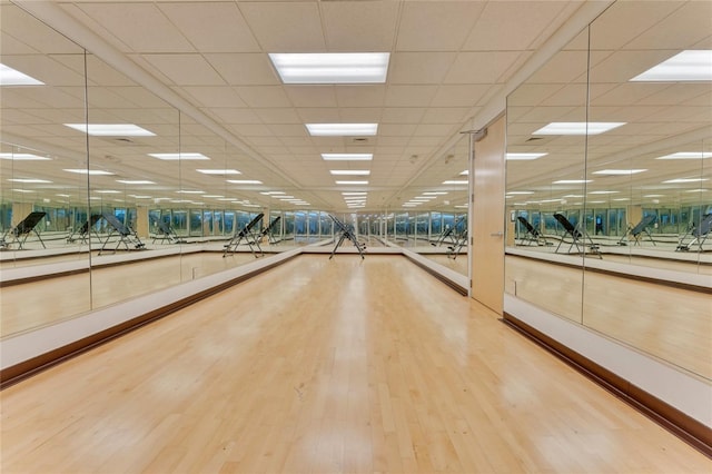 interior space featuring a drop ceiling and light hardwood / wood-style floors