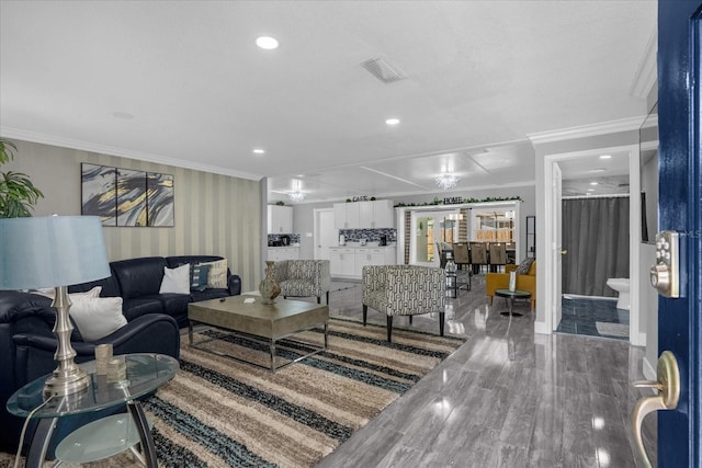 living room with ornamental molding and hardwood / wood-style floors