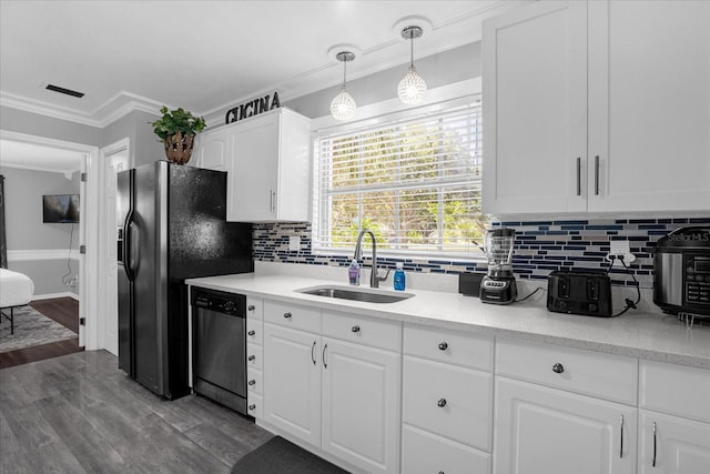 kitchen featuring sink, dishwasher, white cabinetry, hanging light fixtures, and ornamental molding