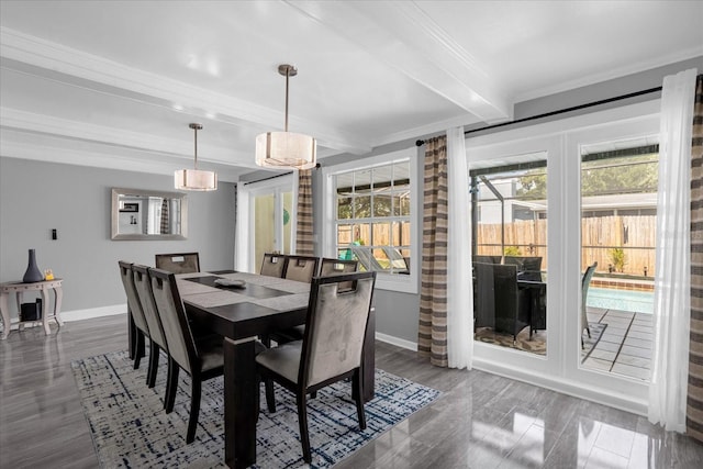 dining area featuring a healthy amount of sunlight, dark wood-type flooring, and beam ceiling