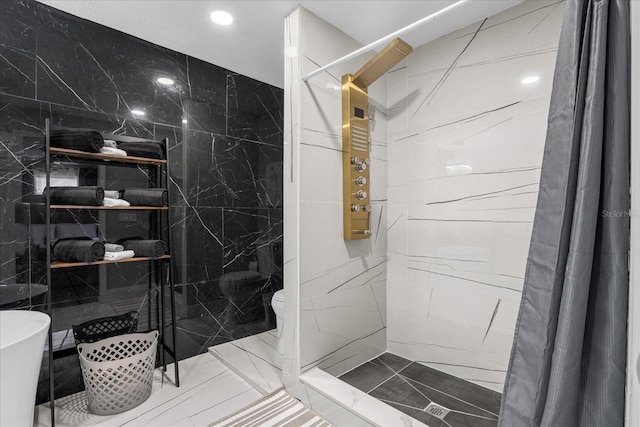 bathroom featuring tile walls, toilet, and a shower with shower curtain