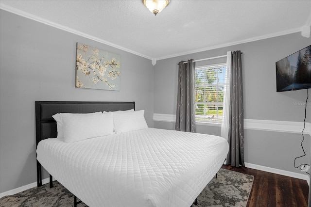 bedroom with dark hardwood / wood-style flooring, crown molding, and a textured ceiling