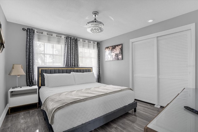 bedroom featuring dark hardwood / wood-style floors, a closet, and a textured ceiling