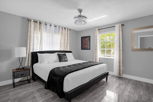 bedroom with hardwood / wood-style flooring and a textured ceiling