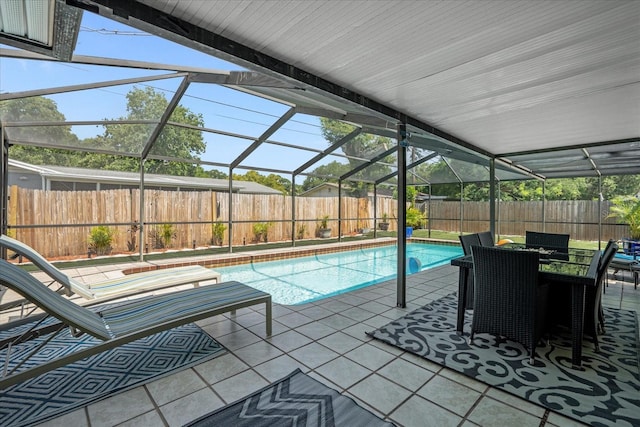 view of swimming pool with glass enclosure and a patio area