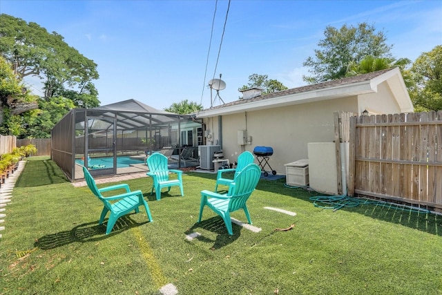 view of yard featuring a fenced in pool, a lanai, and central AC unit