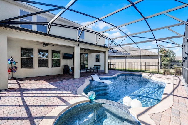 view of pool with ceiling fan, a lanai, an in ground hot tub, and a patio area