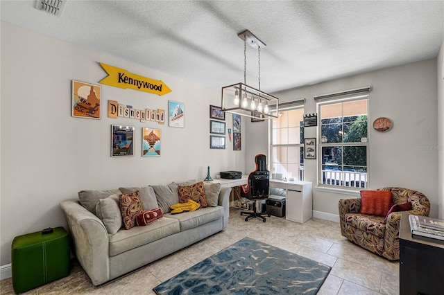 living room featuring a textured ceiling, light tile patterned floors, and a notable chandelier