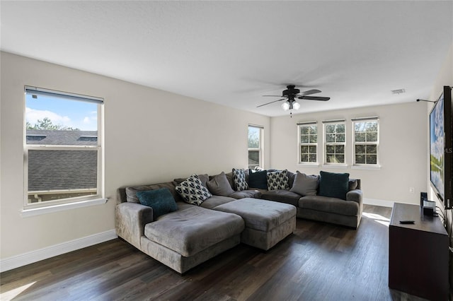 living room featuring ceiling fan, dark hardwood / wood-style flooring, and plenty of natural light