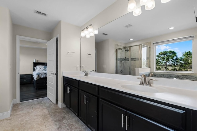 bathroom with a shower with door and vanity