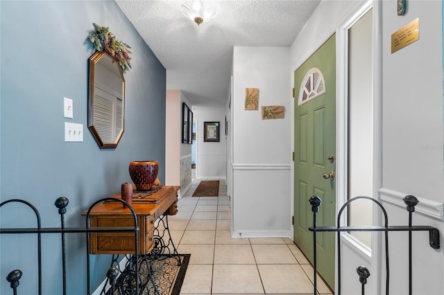 corridor featuring a textured ceiling and light tile patterned flooring