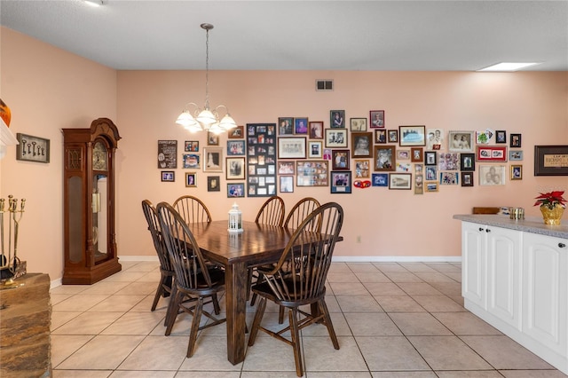 dining room with baseboards, visible vents, a chandelier, and light tile patterned flooring