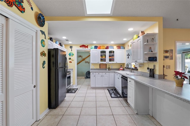 kitchen featuring black appliances, white cabinetry, open shelves, a sink, and light tile patterned flooring