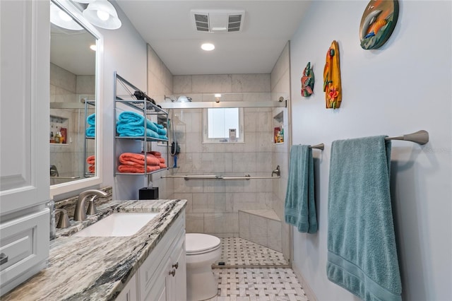 full bathroom featuring toilet, a stall shower, visible vents, and vanity