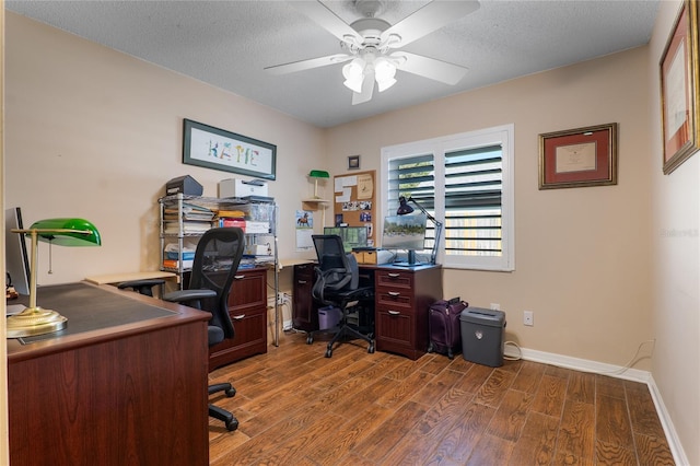 office space featuring ceiling fan, a textured ceiling, baseboards, and wood finished floors