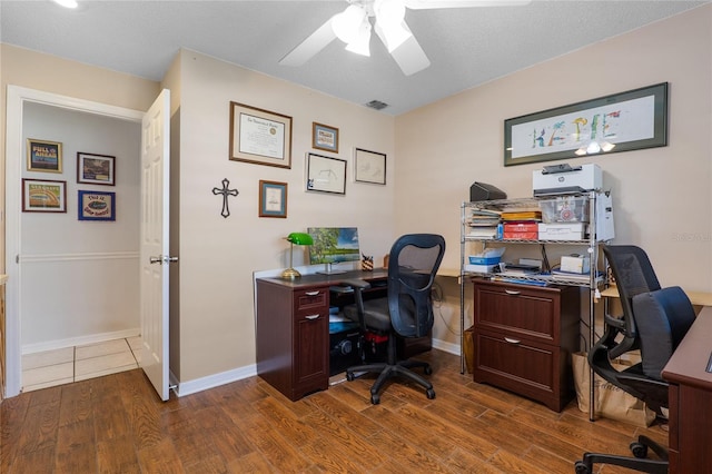 home office with baseboards, wood finished floors, visible vents, and a ceiling fan