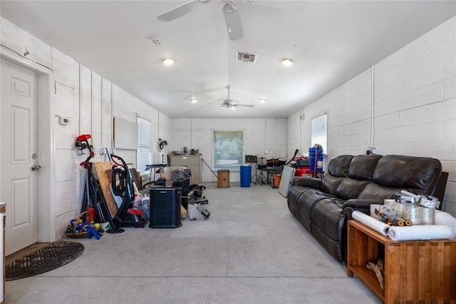 living area featuring ceiling fan, visible vents, and concrete flooring