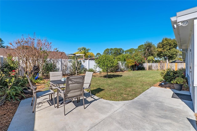 view of patio with outdoor dining area and a fenced backyard