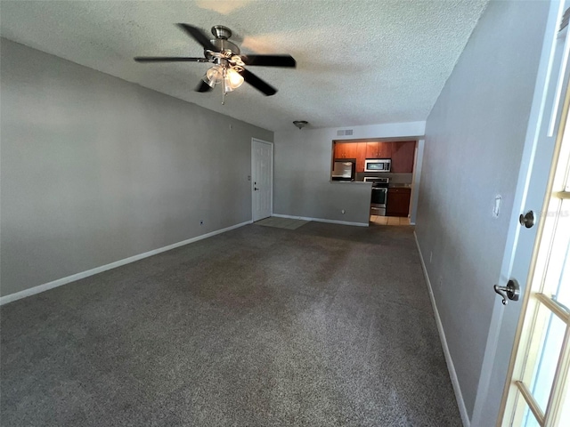 unfurnished living room featuring ceiling fan, carpet floors, and a textured ceiling