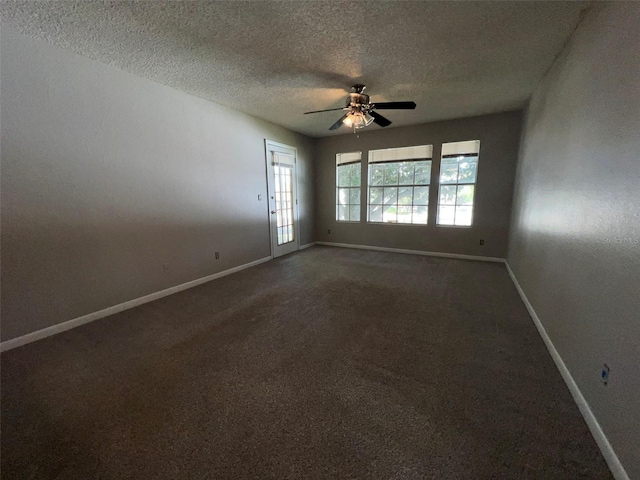 unfurnished room with ceiling fan and a textured ceiling