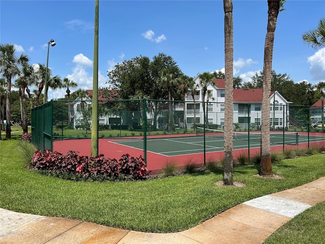 view of tennis court with a lawn