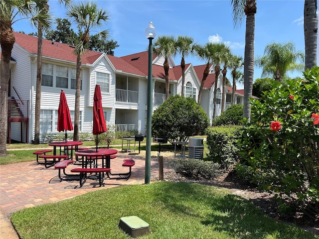 view of home's community featuring a patio area and a yard