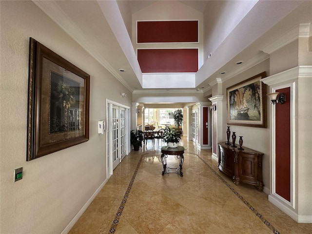 11538 Westwood Blvd Unit 226, Orlando, FL 32821 - hall featuring inlaid floor details, a high ceiling, crown molding, and decorative columns